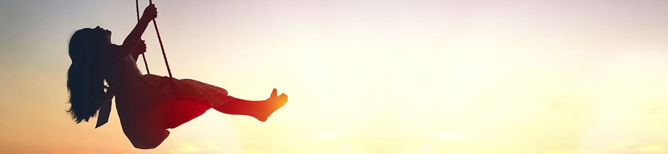 Girl on a swing, sun is setting